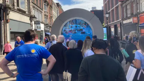BBC Dubliners take in the livestream link with New York