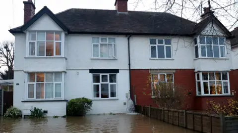 Reuters Brown water is seen filling the front garden of a semi-detached house in Hereford 