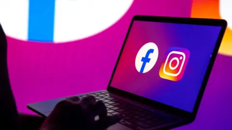 Getty Images Facebook and Instagram icons on a laptop