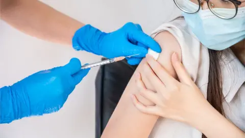 Getty Images Young person being given vaccination stock image