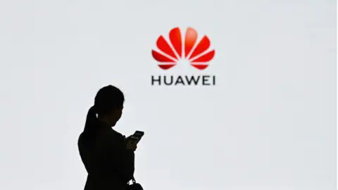 Getty Images Woman in front of Huawei logo