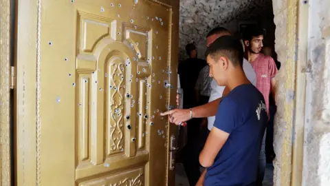 EPA People check damage in a house where two Palestinians were killed during an Israeli raid in Nablus