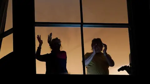 Getty Images People applauding from balconies