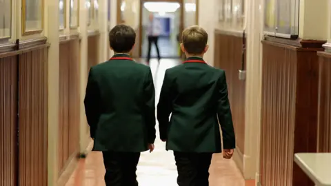 Getty Images Two boys walking down a corridor at Altrincham Grammar School
