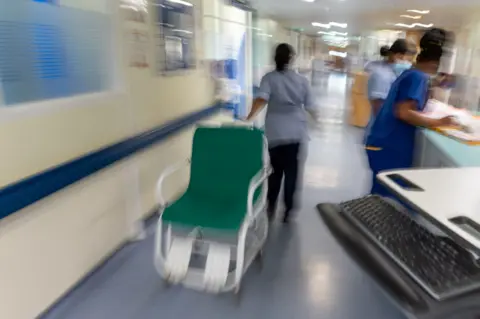 PA Media NHS ward staff hurry to care for patients