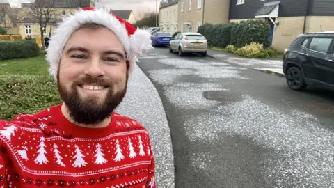 Andy Brunning Andy Brunning taking a selfie with the "sprinkling of snow" in Ely, Cambridgeshire.