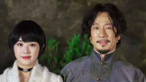 Getty Images Zhang Hanyun standing beside Zhao Lixin