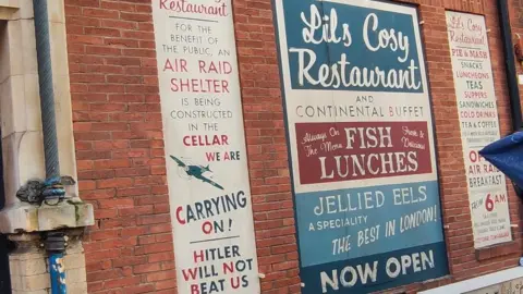Paul Schofield 1940s signs on wall