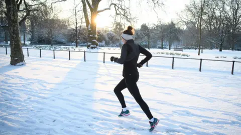 LeonNeal/Getty Runner in snow