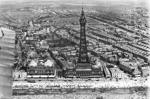 Historic England Archive / Aerofilms Collection An aerial view of Blackpool Tower and the Winter Gardens in Blackpool, Lancashire, taken in July 1920