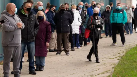 Getty Images Queue of people outside Merthyr Tydfil Leisure Centre