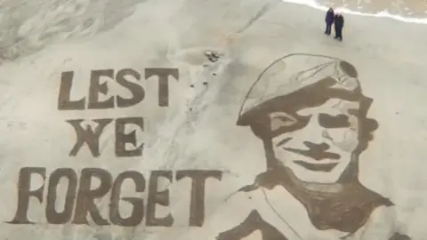 Jon Barnes/Ebb and Flow Rake Art A sand art drawing depicting Herbie Bray, thought to be one of the last surviving British paratroopers, who died in October aged 97.
