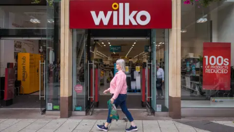 Getty Images Woman walks past Wilko shop