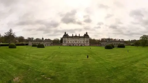 Shaun Whitmore/BBC Wide shot shows Houghton Hall in the background with cast-iron figures dotted on the sprawling green lawn.