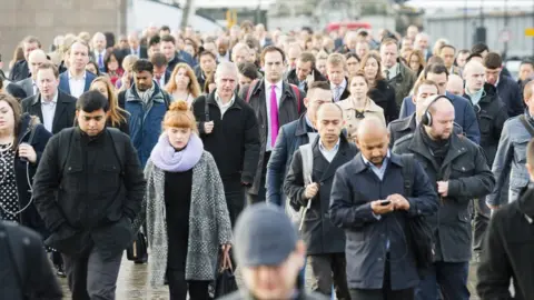 Getty Images People walking across a bridge