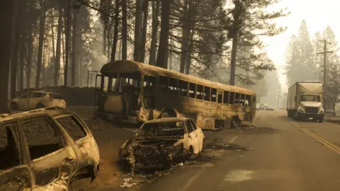 EPA Abandoned cars from fleeing residents of the Magalia and Paradise Pine area, line Skyway road