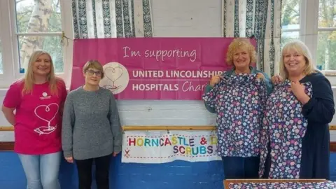 United Lincolnshire Hospitals NHS Trust Staff and volunteers with the pyjama gowns