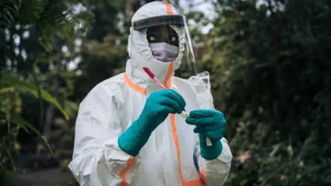 Getty Images A staff member of the Congolese Ministry of Health prepares the sampling equipment to perform a COVID-19 test at a private residence in Goma, northeastern Democratic Republic of Congo, on March 31, 2020