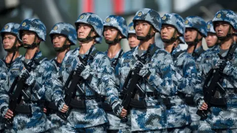 Getty Images People's Liberation Army soldiers prepare for the arrival of China's President Xi Jinping at the Shek Kong barracks in Hong Kong on 30 June 2017