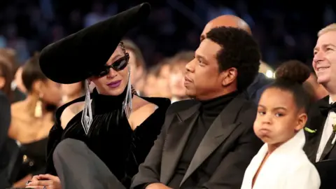 Getty Images Blue Ivy with her parents at the 2018 Grammy Awards