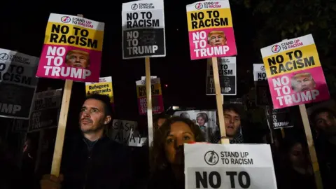 AFP / GETTY "No to racism, no to Trump" banners