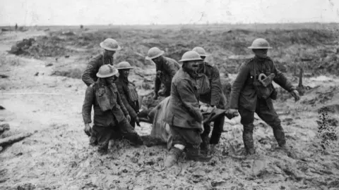 John Warwick Brooke A stretcher-bearing party carrying a wounded soldier through the mud near Boesinghe during the battle of Passchendaele in Flanders