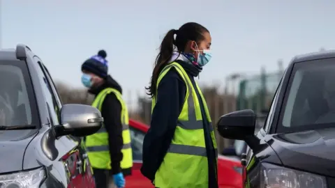 Reuters Workers at a coronavirus testing centre