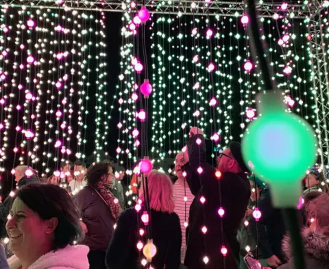 Pritti Mistry Crowds of people in a curtain of light