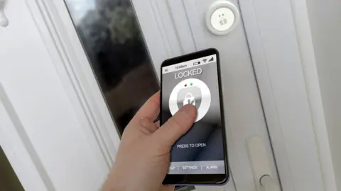 Getty Images A staged picture of a smartphone and door