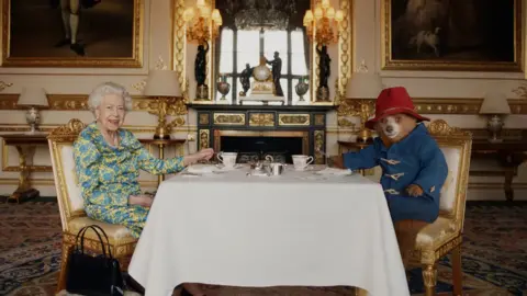 Buckingham Palace/ Studio Canal / BBC Studios The Queen meets Paddington Bear for tea