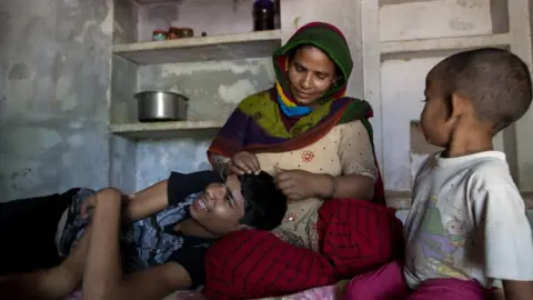 Mansi Thapliyal Hassan smiling with his head in his mom's lap