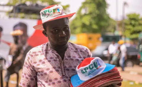 BBC Man selling APC hats