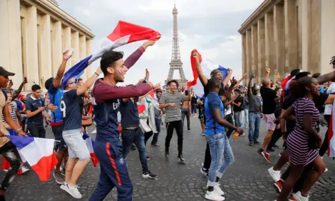 Reuters French fans in Paris celebrate in front of the Eiffel Tower, 15 July 2018