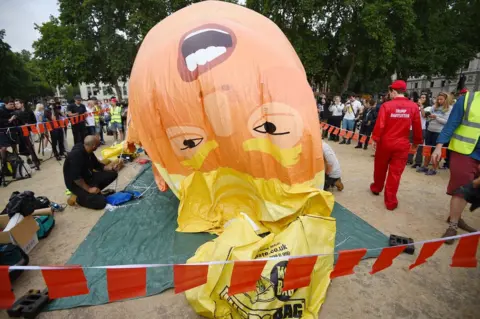 PA A "Baby Trump" balloon is inflated in London's Parliament Square