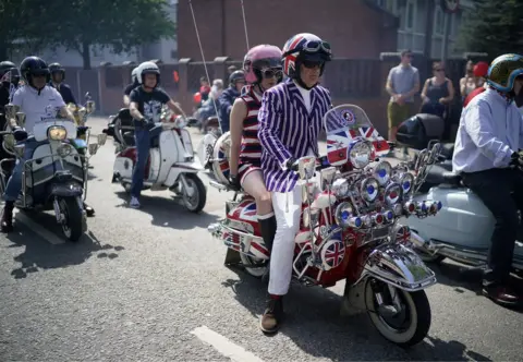 Christopher Furlong/Getty Images Scooter parade down the street as they take part in the Manchester St George's Day parade
