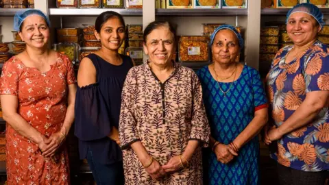 Dan Newell Vijaya Popat (centre) and some of her team