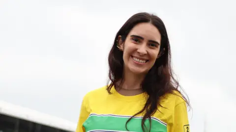 Getty Images Lalalli Senna, the niece of Ayrton Senna, pictured wearing the colours of his helmet