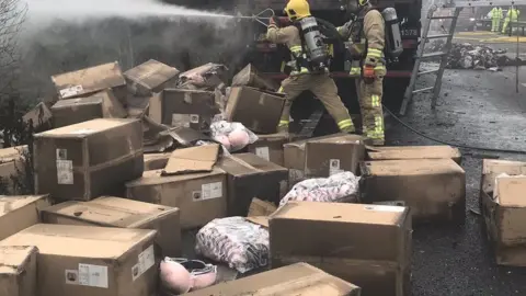 Suffolk Fire and Rescue Charred boxes removed from burnt-out lorry on the A14.