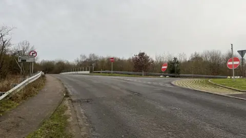 The junction of the road with temporary no-entry signs