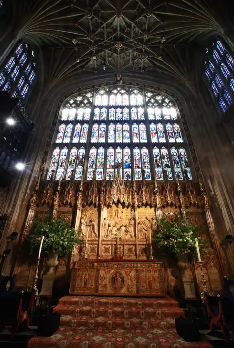 Danny Lawson/PA Flowers and foliage surround the High Altar of St George's Chapel at Windsor Castle for the wedding of Prince Harry to Meghan Markle.