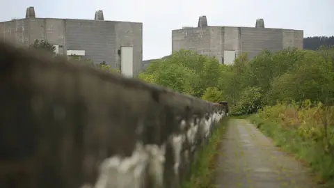 Getty Images Two reactor towers at Trawsfynydd with disused overgrown path in foreground