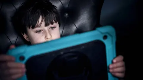 Getty Images A boy watching an iPad