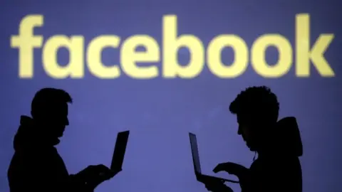 Reuters Facebook logo with two people in silhouette