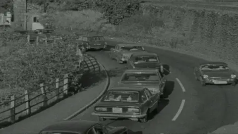 Cars queue on the Cob in Porthmadog in 1971