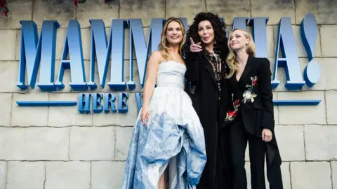 Getty Images Lily James, Cher and Amanda Seyfried attend the UK Premiere of Mamma Mia! Here We Go Again in 2018