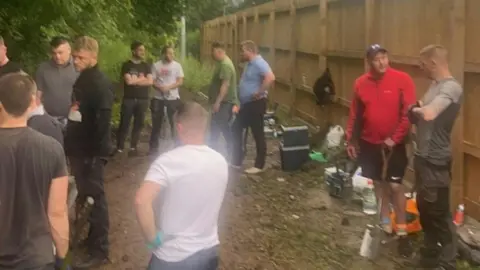 Mel Smith Men taking part in a dig at the site
