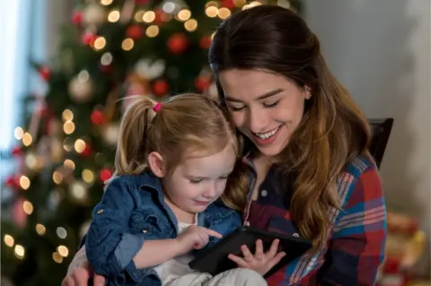 Getty Images Mum and daughter read an e-book