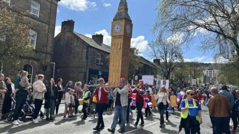 Julia Bryson/BBC A giant model of Big Ben was carried along the route