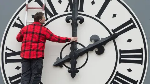 Getty Images A man working on a clock in Dresden, eastern Germany