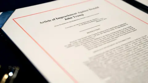 Getty Images An article of impeachment for incitement of insurrection against President Donald Trump sits on a table at the US Capitol on 13 January